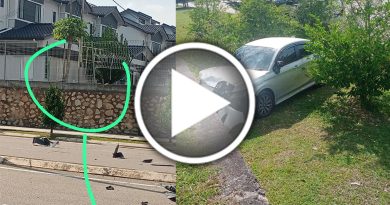 华女疑误踩油门 轿车冲破围栏坠斜坡